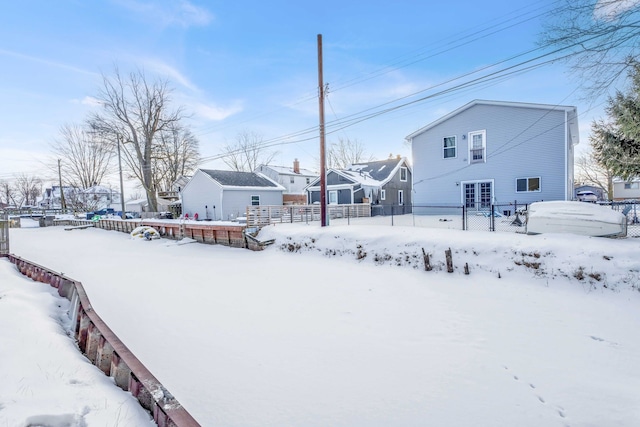 snowy yard featuring fence