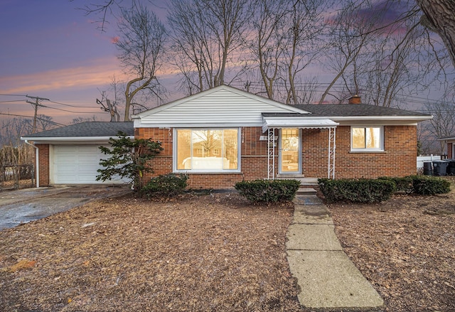 view of front facade featuring a chimney, aphalt driveway, roof with shingles, an attached garage, and brick siding