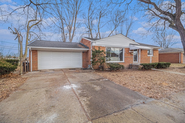 view of front of property with brick siding, driveway, and an attached garage