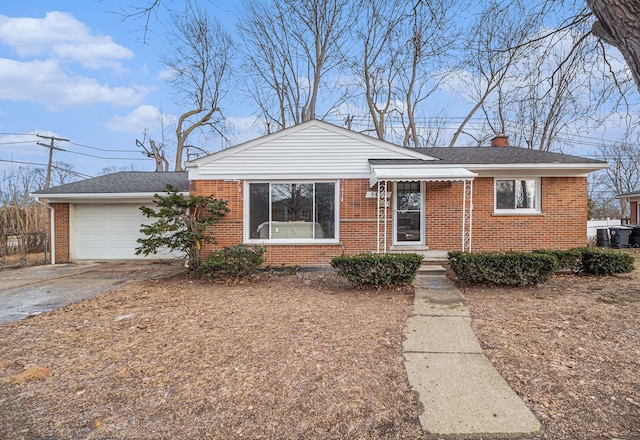 view of front of home with a shingled roof, a chimney, aphalt driveway, an attached garage, and brick siding