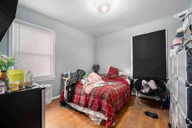 bedroom featuring wood finished floors and baseboards