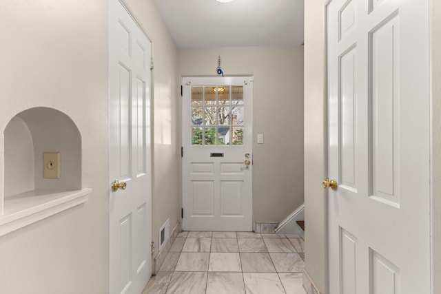 doorway featuring marble finish floor, baseboards, and visible vents