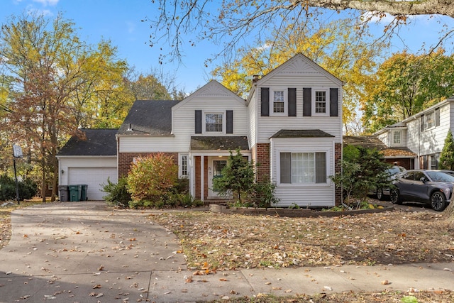 traditional-style house with concrete driveway and brick siding