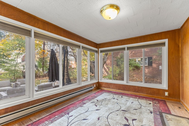 unfurnished sunroom featuring baseboard heating