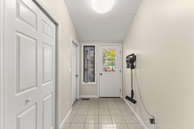 entryway featuring baseboards and light tile patterned floors