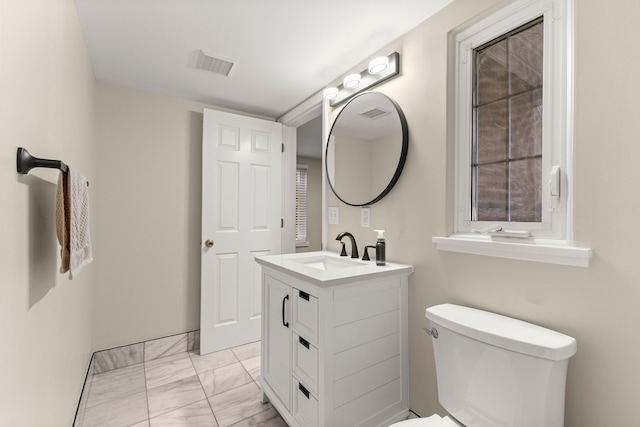 bathroom with toilet, marble finish floor, visible vents, and vanity