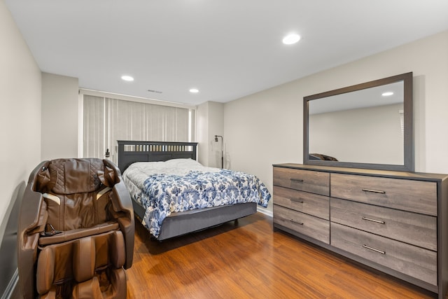 bedroom with visible vents, wood finished floors, and recessed lighting