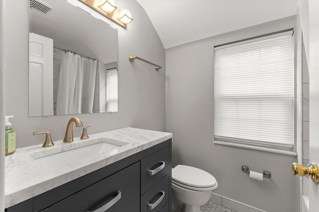 full bathroom featuring baseboards, visible vents, toilet, vaulted ceiling, and vanity