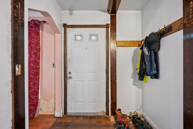 entryway featuring arched walkways and wood finished floors