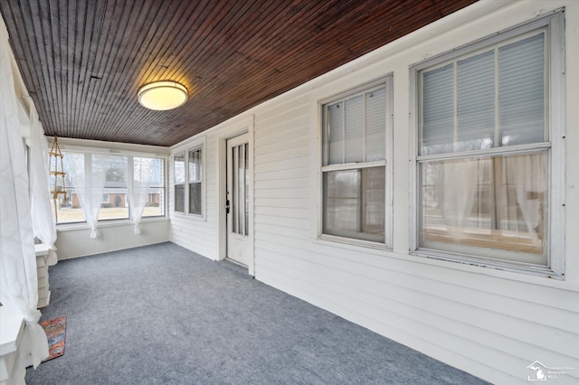 unfurnished sunroom featuring wooden ceiling