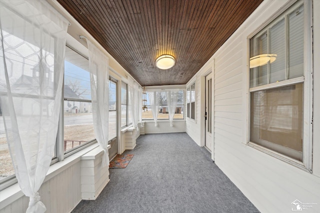 unfurnished sunroom featuring wooden ceiling