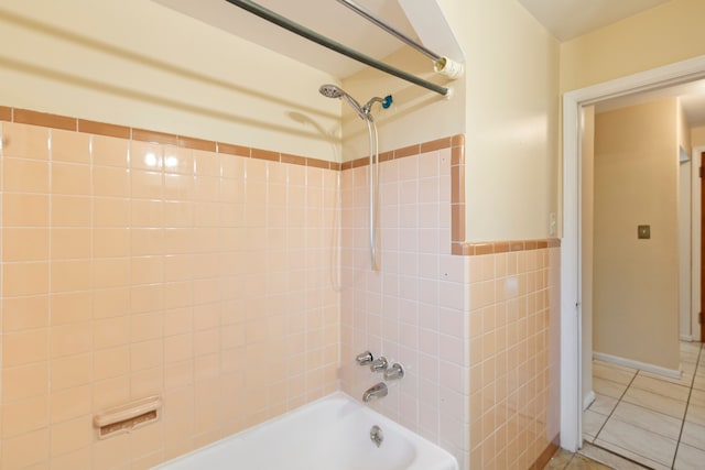 bathroom featuring shower / bathtub combination, tile walls, and tile patterned floors