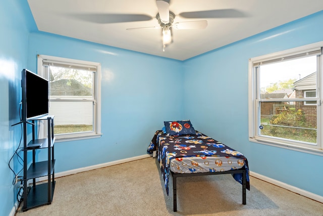 bedroom featuring carpet floors, multiple windows, and baseboards