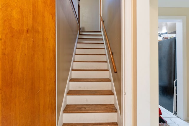 stairway with tile patterned floors