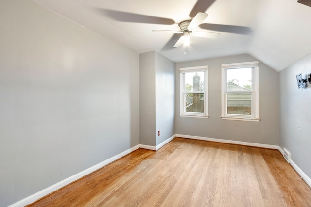 bonus room featuring ceiling fan, visible vents, baseboards, vaulted ceiling, and light wood-type flooring