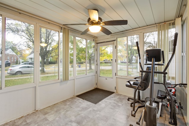 unfurnished sunroom with ceiling fan