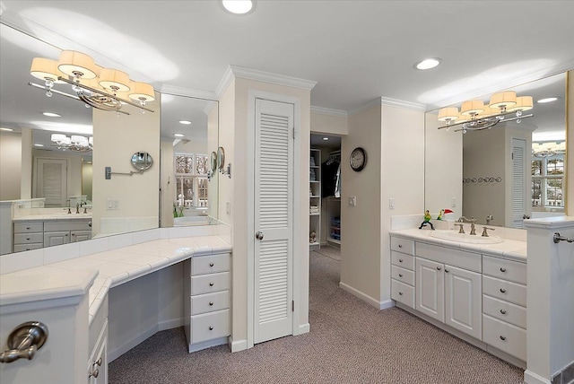 bathroom with ornamental molding, two vanities, a sink, and recessed lighting