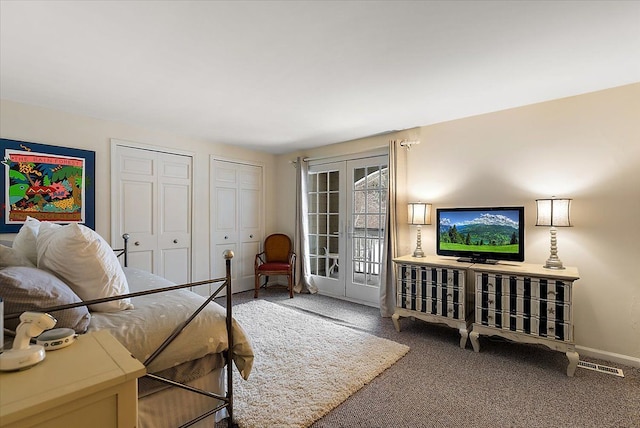 bedroom with french doors, two closets, visible vents, carpet flooring, and baseboards