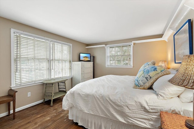 bedroom with baseboards and wood finished floors