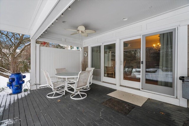 wooden terrace with a ceiling fan and outdoor dining area