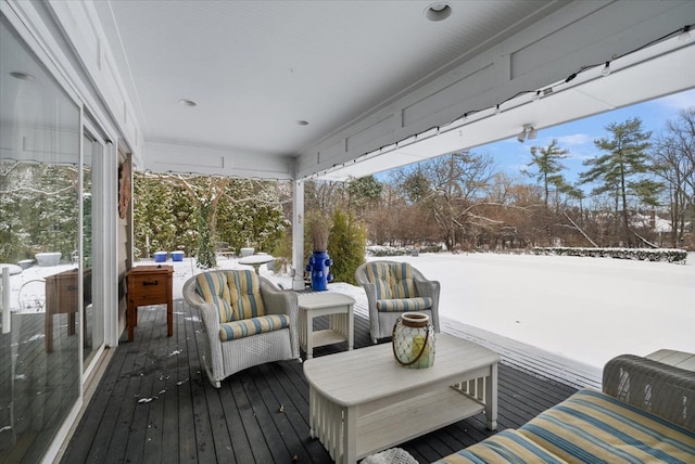 snow covered deck featuring outdoor lounge area