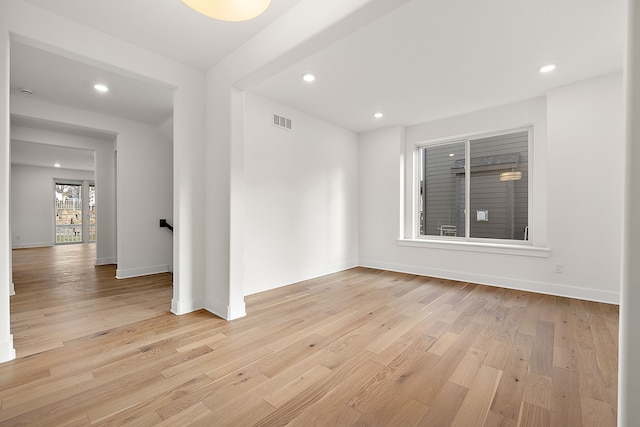 spare room with light wood-type flooring, visible vents, baseboards, and recessed lighting