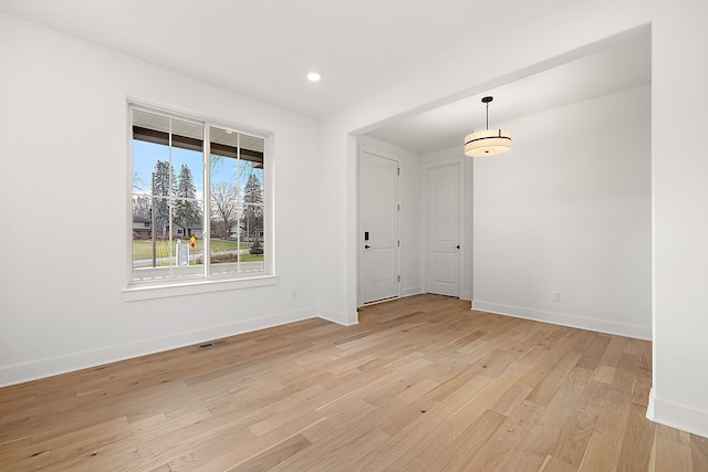 unfurnished room with light wood-style flooring, recessed lighting, visible vents, and baseboards