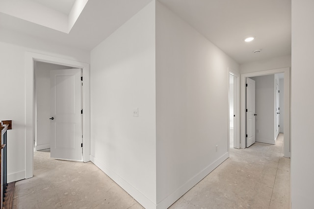 hallway with baseboards and recessed lighting