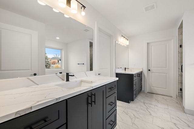 bathroom featuring two vanities, marble finish floor, visible vents, and a sink