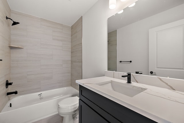 bathroom featuring washtub / shower combination, vanity, and toilet