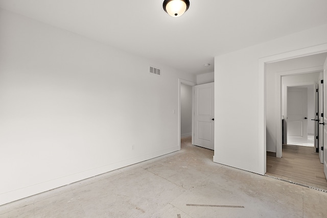 unfurnished bedroom featuring concrete flooring, visible vents, and baseboards