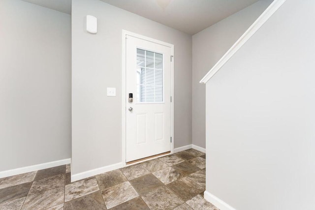 interior space featuring stone finish floor and baseboards