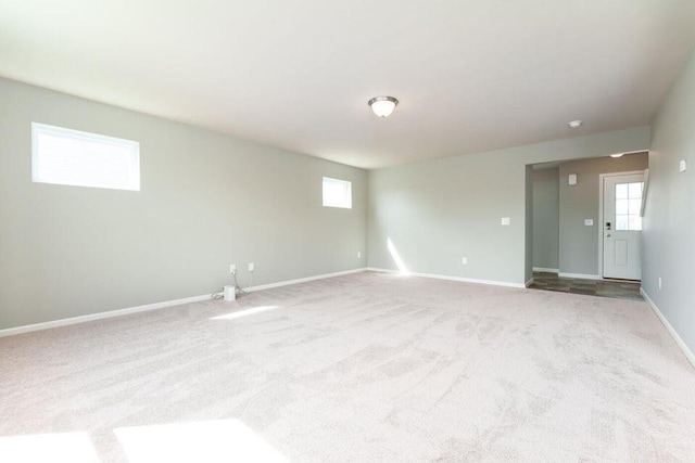 carpeted empty room with baseboards