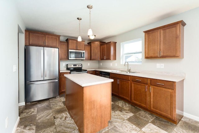 kitchen featuring baseboards, appliances with stainless steel finishes, a sink, and brown cabinets