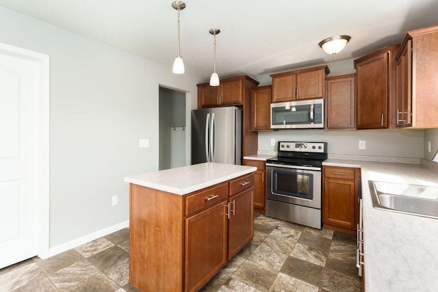 kitchen with brown cabinets, a kitchen island, appliances with stainless steel finishes, and light countertops