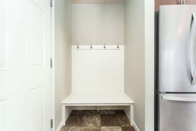 mudroom with stone finish floor and baseboards