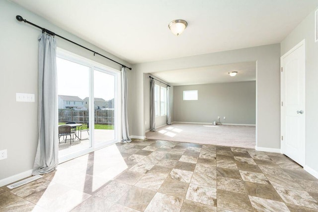 empty room featuring visible vents and baseboards