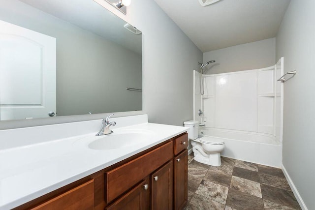 full bathroom featuring shower / bathing tub combination, toilet, stone finish flooring, vanity, and baseboards