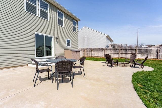 view of patio / terrace with an outdoor fire pit, fence, and outdoor dining area