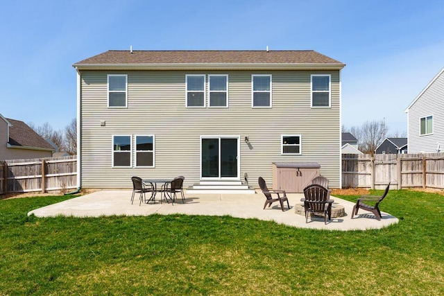 rear view of house featuring a yard, a patio area, and a fenced backyard