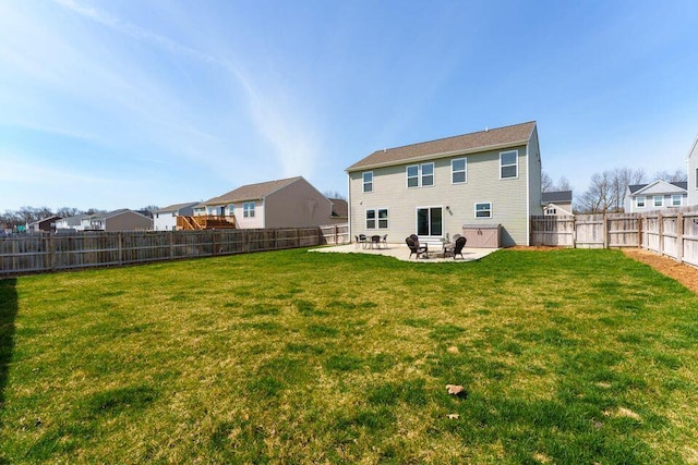 rear view of house with a yard, a fenced backyard, and a patio