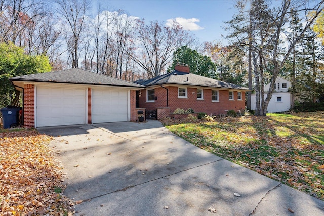 ranch-style house with a garage, a chimney, concrete driveway, and brick siding