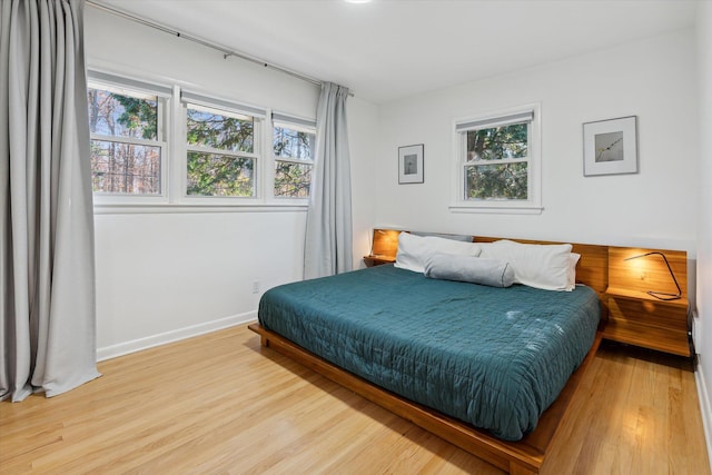 bedroom with wood finished floors and baseboards