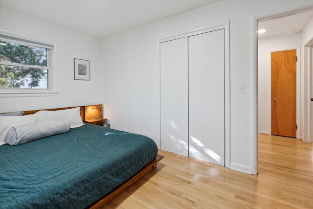 bedroom with a closet and light wood finished floors