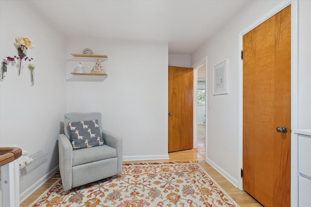 sitting room featuring light wood-style floors and baseboards