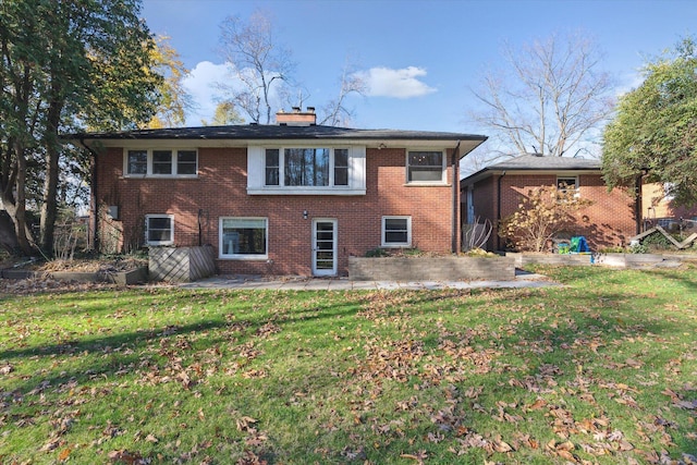 back of house with brick siding, a chimney, and a patio area