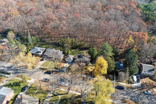 birds eye view of property featuring a view of trees