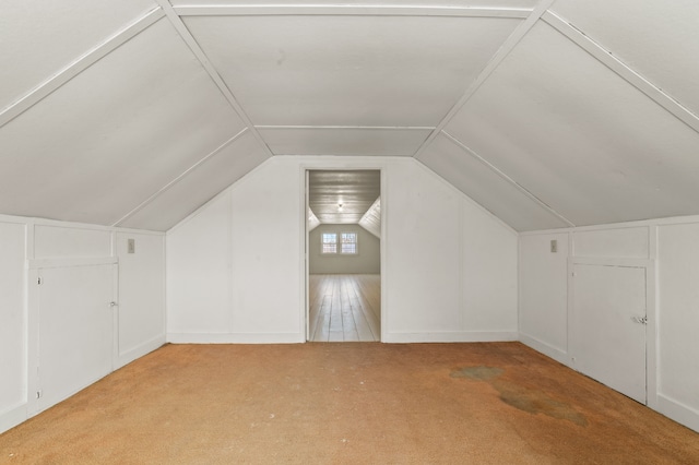 bonus room featuring lofted ceiling and light carpet