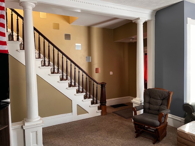 staircase featuring carpet floors, decorative columns, and baseboards