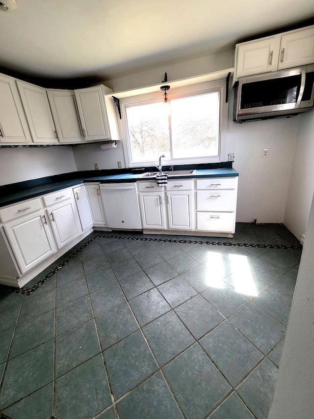 3246 E Maple Ave, Grand Blanc, MI 48507 - kitchen featuring white cabinets, dark countertops, stainless steel microwave, white dishwasher, and dark tile patterned floors